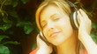 Young woman listens to music. Dreamy look.