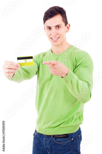 Photo: Smiling young man pointing to credit card on white background Smiling young man pointing to credit card on white background