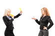 Woman in suit showing a yellow card and blowing a whistle to a f