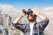 Young Man With Binocular At Mo...