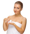 Young girl with body cream jar