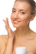 Young girl applying cream