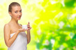 Young girl with body cream jar on floral  background