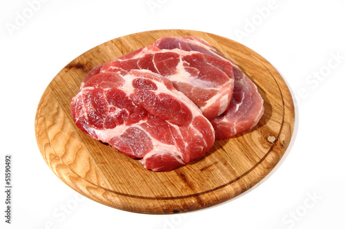 Photo: raw meat steak on the wooden board raw meat steak on the wooden board