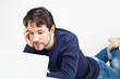young man working on laptop while laying on the floor