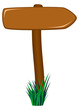 Wooden road sign as arrow in grass