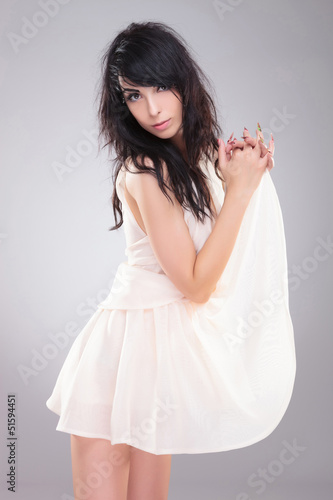 Photo: fashion woman holding her dress fashion woman holding her dress
