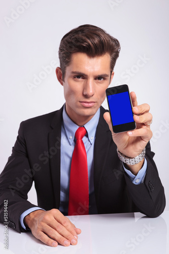 Photo: business man shows phone business man shows phone
