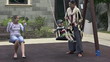 Girlfriends with kid playing on the swing, super slow motion