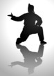 Vector: Silhouette illustration of a man in pencak silat stance Silhouette illustration of a man in pencak silat stance