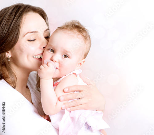 Photo: Mother and Baby kissing and hugging. Happy Family Mother and Baby kissing and hugging. Happy Family