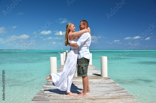 Photo: A couple on the wooden jetty. Exuma, Bahamas A couple on the wooden jetty. Exuma, Bahamas