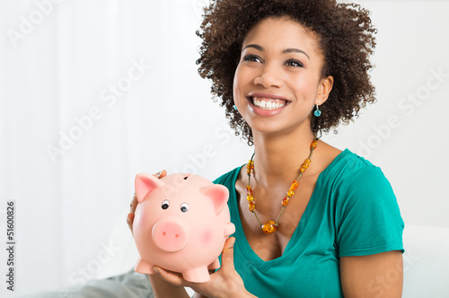 Photo: Happy Woman Holding Piggybank Happy Woman Holding Piggybank