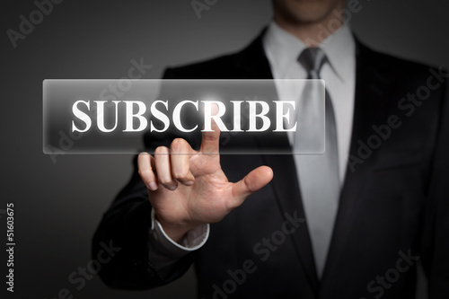 Photo: businessman pressing touchscreen button - subscribe businessman pressing touchscreen button - subscribe