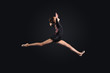 Young woman in gymnast suit posing