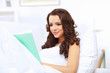 Young woman at home with a book