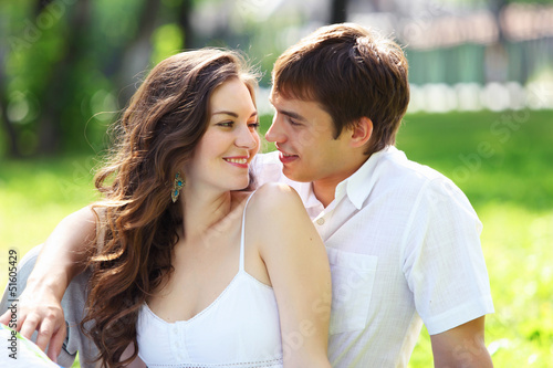 Photo: Young love Couple smiling under blue sky Young love Couple smiling under blue sky