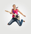 Photo: young woman playing on electro guitar and jumping young woman playing on electro guitar and jumping