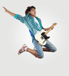 Photo: young man playing on electro guitar and jumping young man playing on electro guitar and jumping