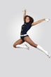 Young female dancer against white background