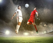 two football players striking the ball