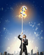 Image of businessman climbing rope