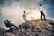 Three business people pulling rope