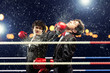 Two young businessman boxing