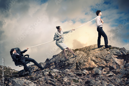 Photo: Three business people pulling rope Three business people pulling rope