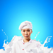 Asian female cook against milk splashes