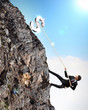 busiessman climbing mountain