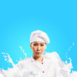 Asian female cook against milk splashes