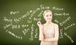 portrait of young teacher near blackboard
