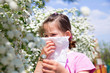 Little girl is blowing her nose