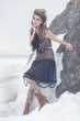 a fashion model posing in a cold winter setting