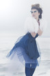 a fashion model posing in a cold winter setting