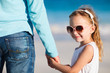 Father and daughter holding hands