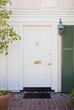 White front door of an upscale home with wreath
