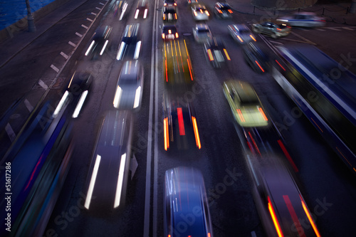 Photo: Car traffic at night. Motion blurred background. Car traffic at night. Motion blurred background.
