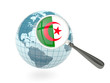 Magnified flag of algeria with blue globe