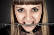 portrait of a brutal woman with a chain in teeth