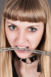 beautiful woman with a chain in teeth