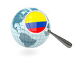 Magnified flag of colombia with blue globe