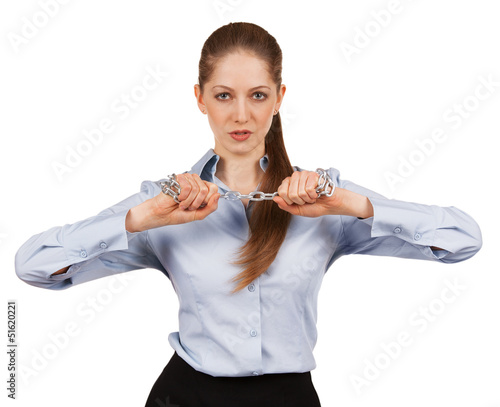 Photo: Young woman trying to break a metal chain Young woman trying to break a metal chain
