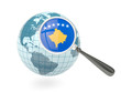Magnified flag of kosovo with blue globe