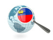 Magnified flag of liechtenstein with blue globe
