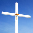 catholic cross with crusifixion sign against blue sky