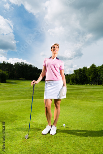 Photo: Young female golf player on course Young female golf player on course