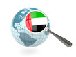 Illustration: Magnified flag of united arab emirates with blue globe Magnified flag of united arab emirates with blue globe