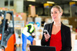 dispatcher using phone at warehouse of forwarding
